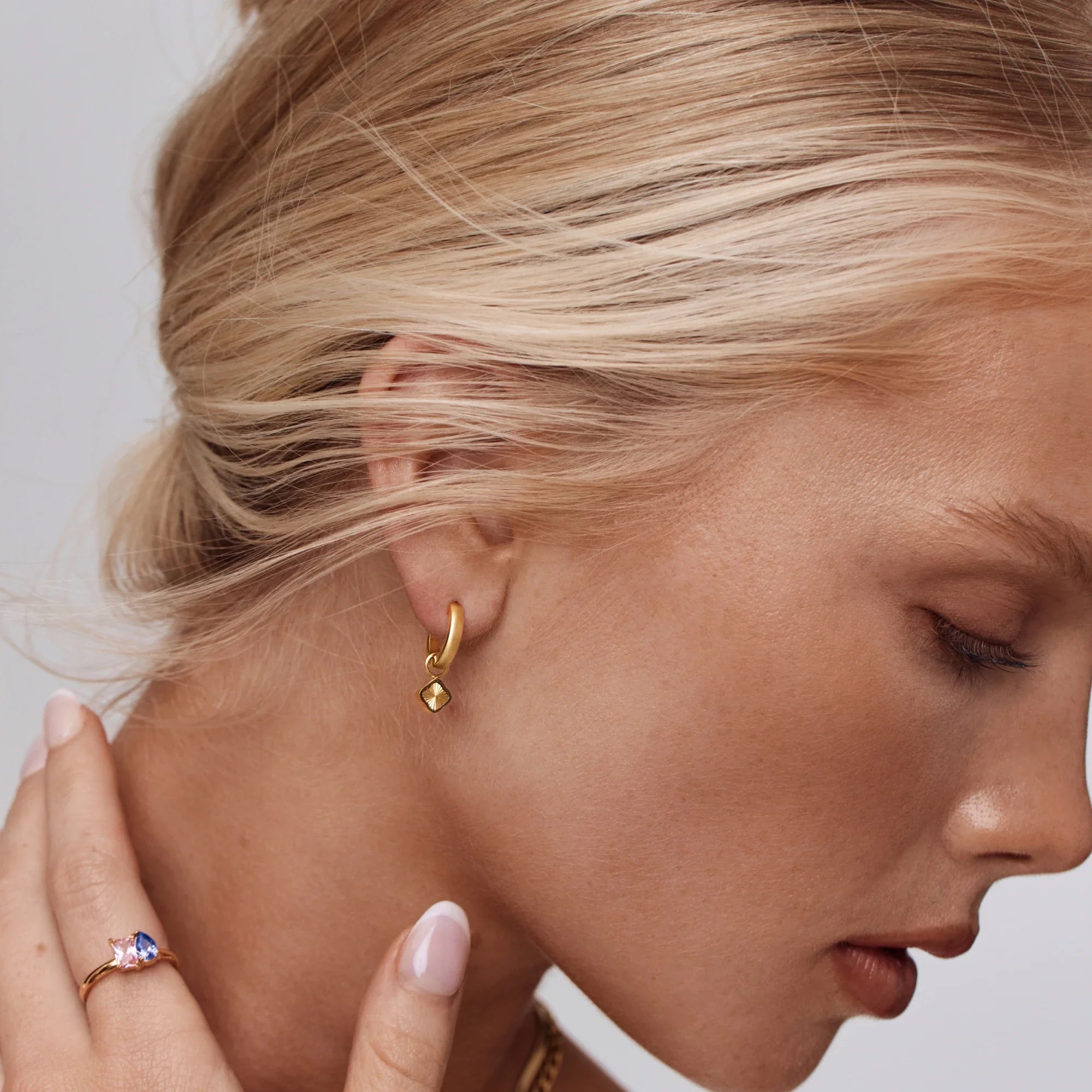 Gold Hoop Earrings with Sunburst Clover Design