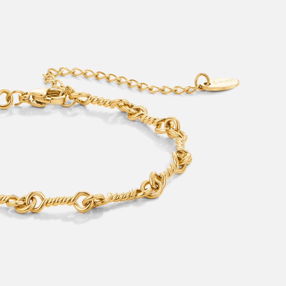 Gold Tone Figaro Knot Chain Bracelet