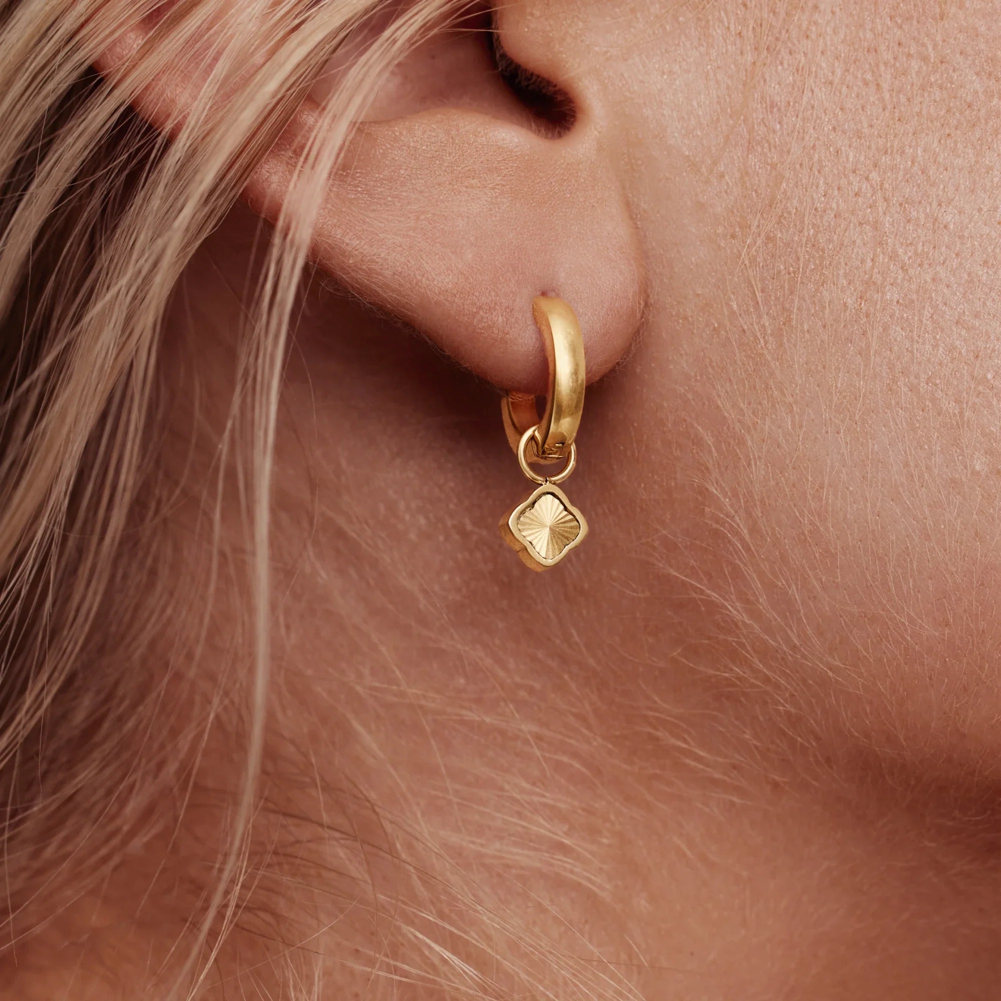 Gold Hoop Earrings with Sunburst Clover Design