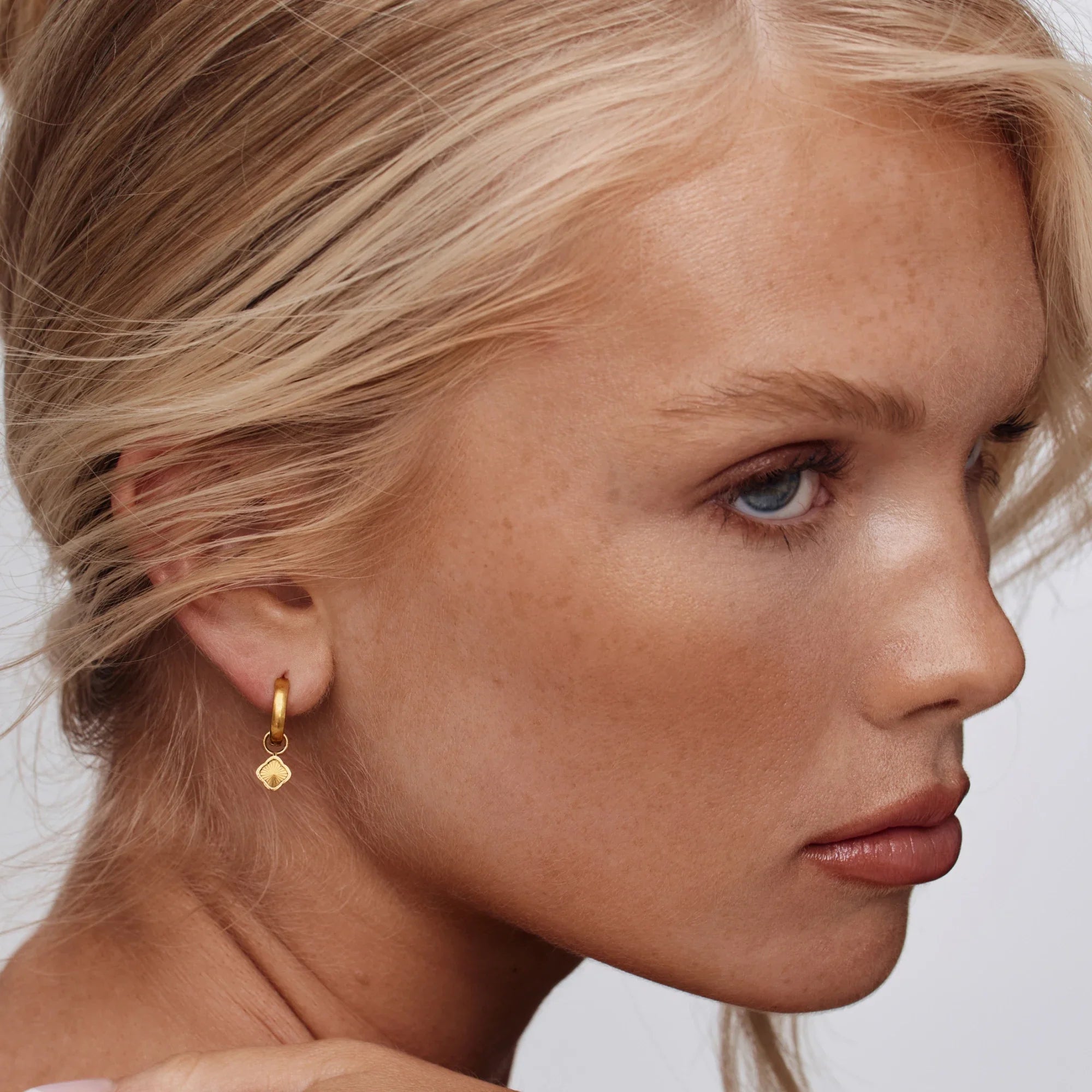 Gold Hoop Earrings with Sunburst Clover Design