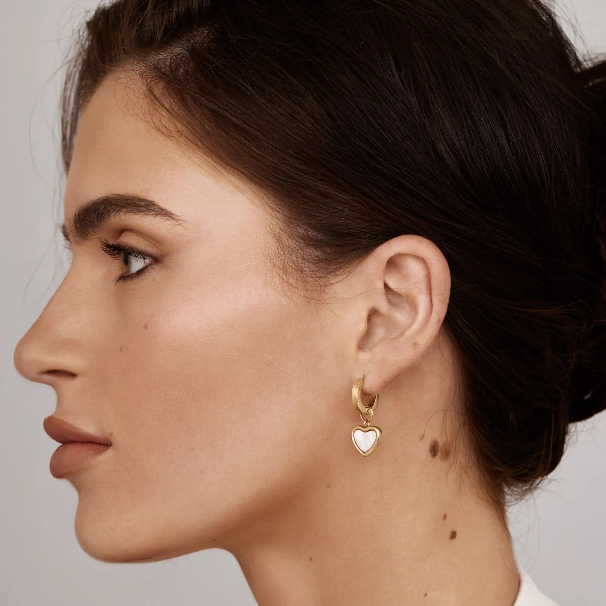 Gold Huggie Earrings with Heart Detail
