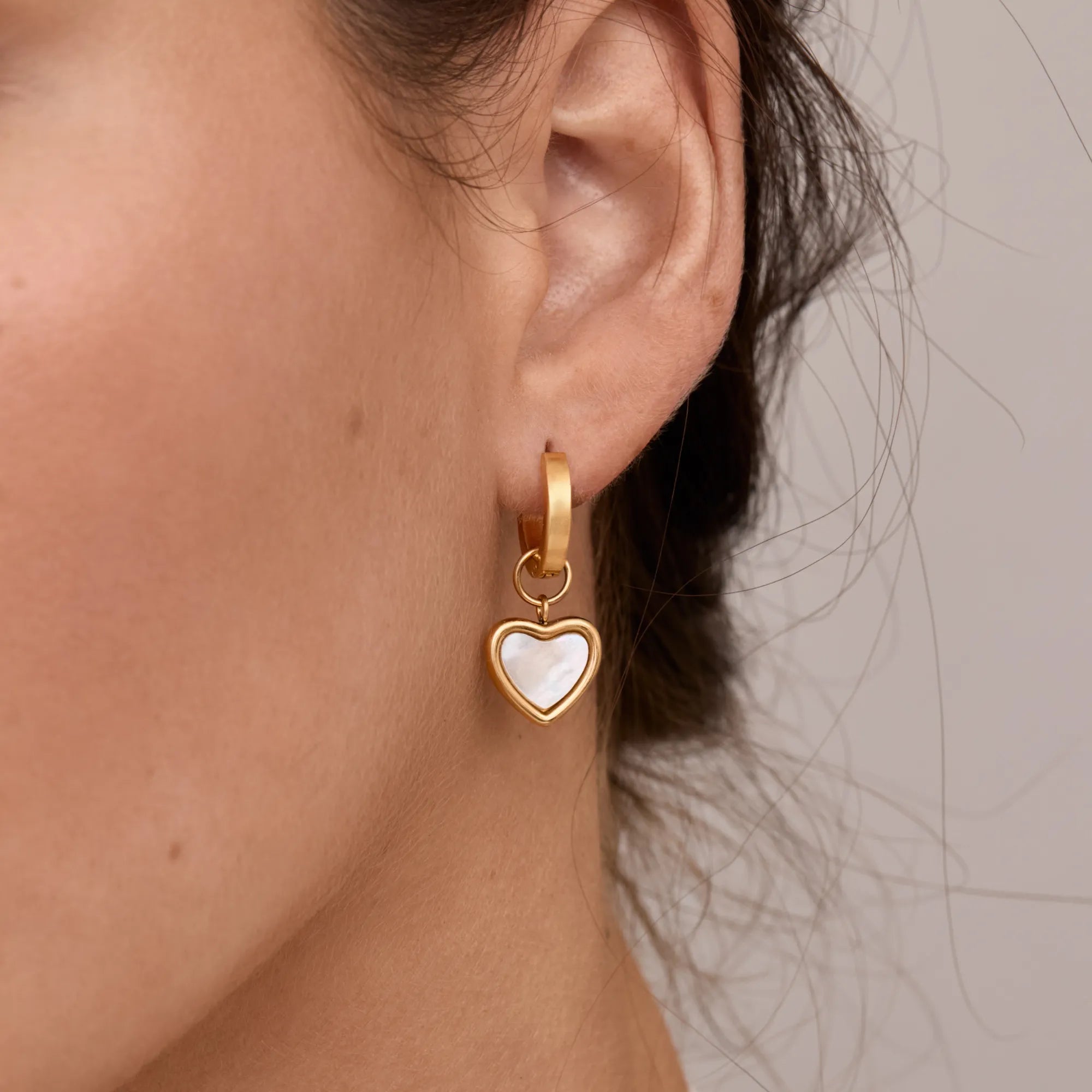 Gold Huggie Earrings with Heart Detail